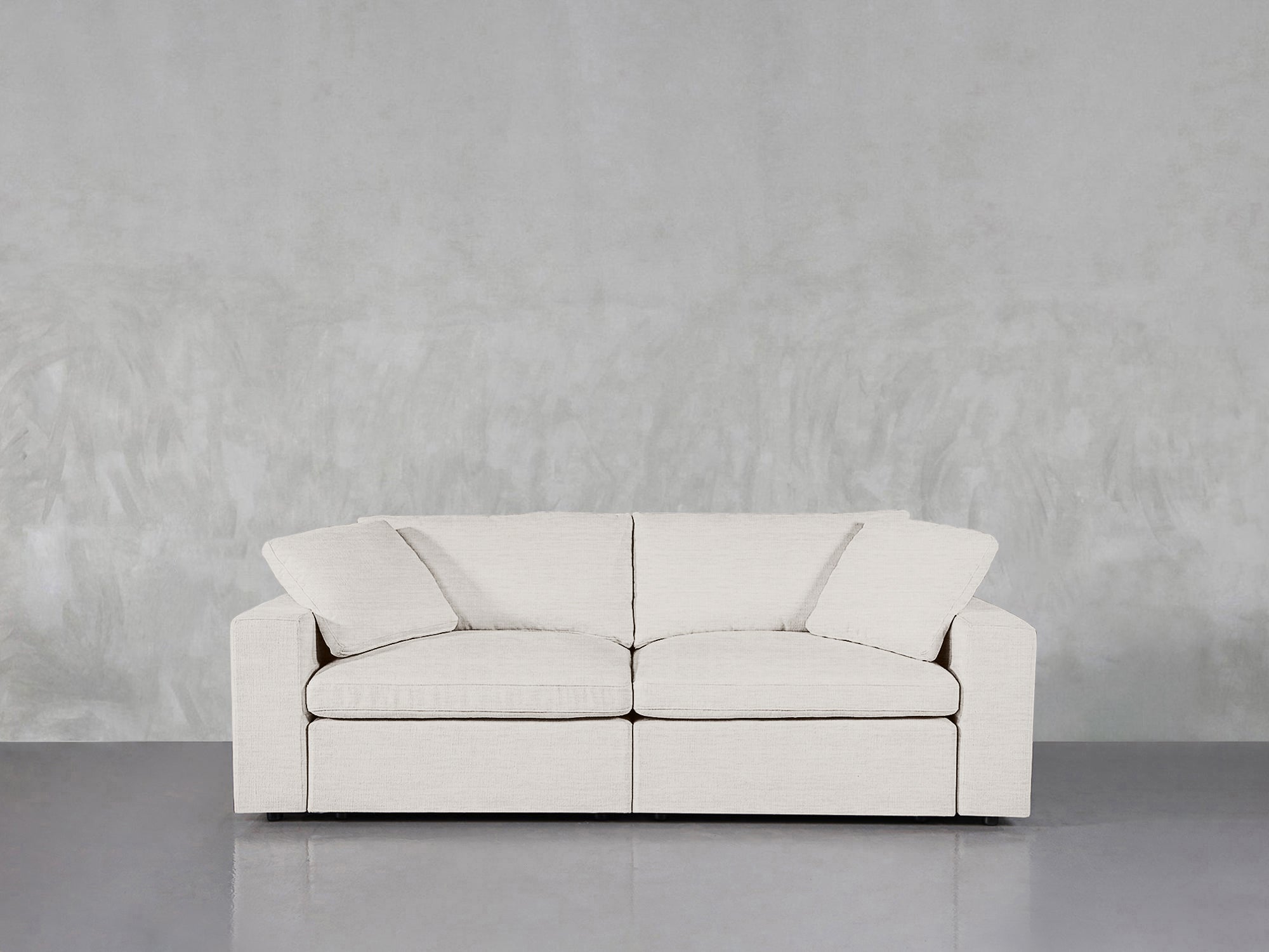 White loveseat in showroom setting