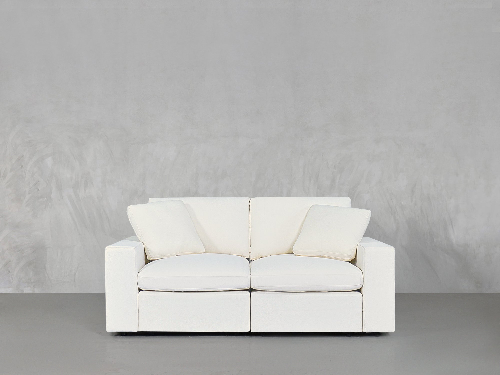White loveseat with matching pillows