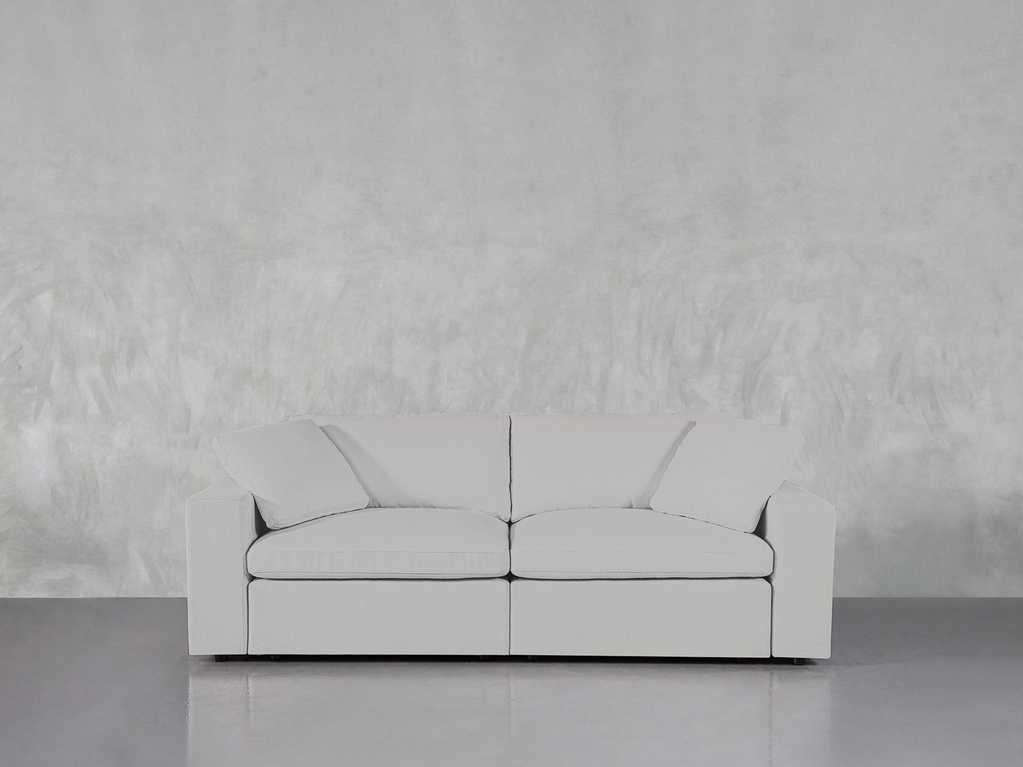 White loveseat against textured wall
