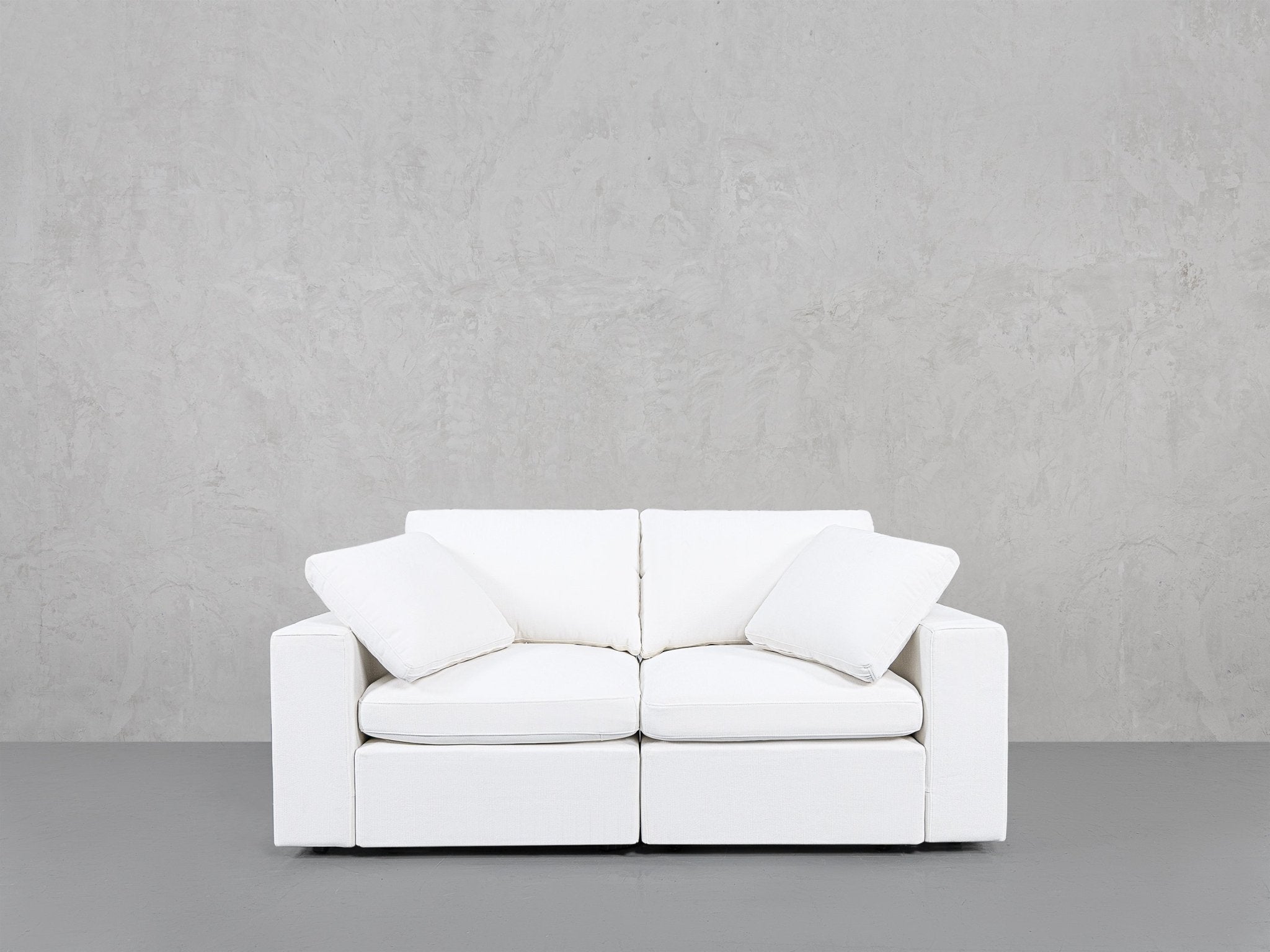 Close-up of cushions on white loveseat