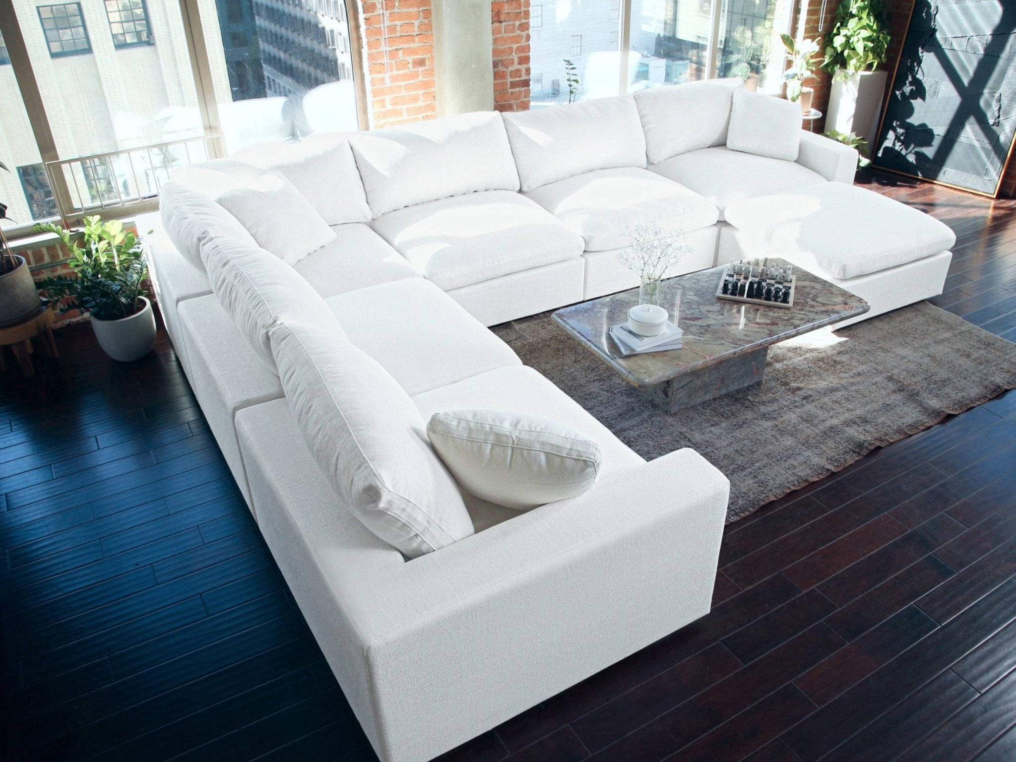 White sectional with glass coffee table