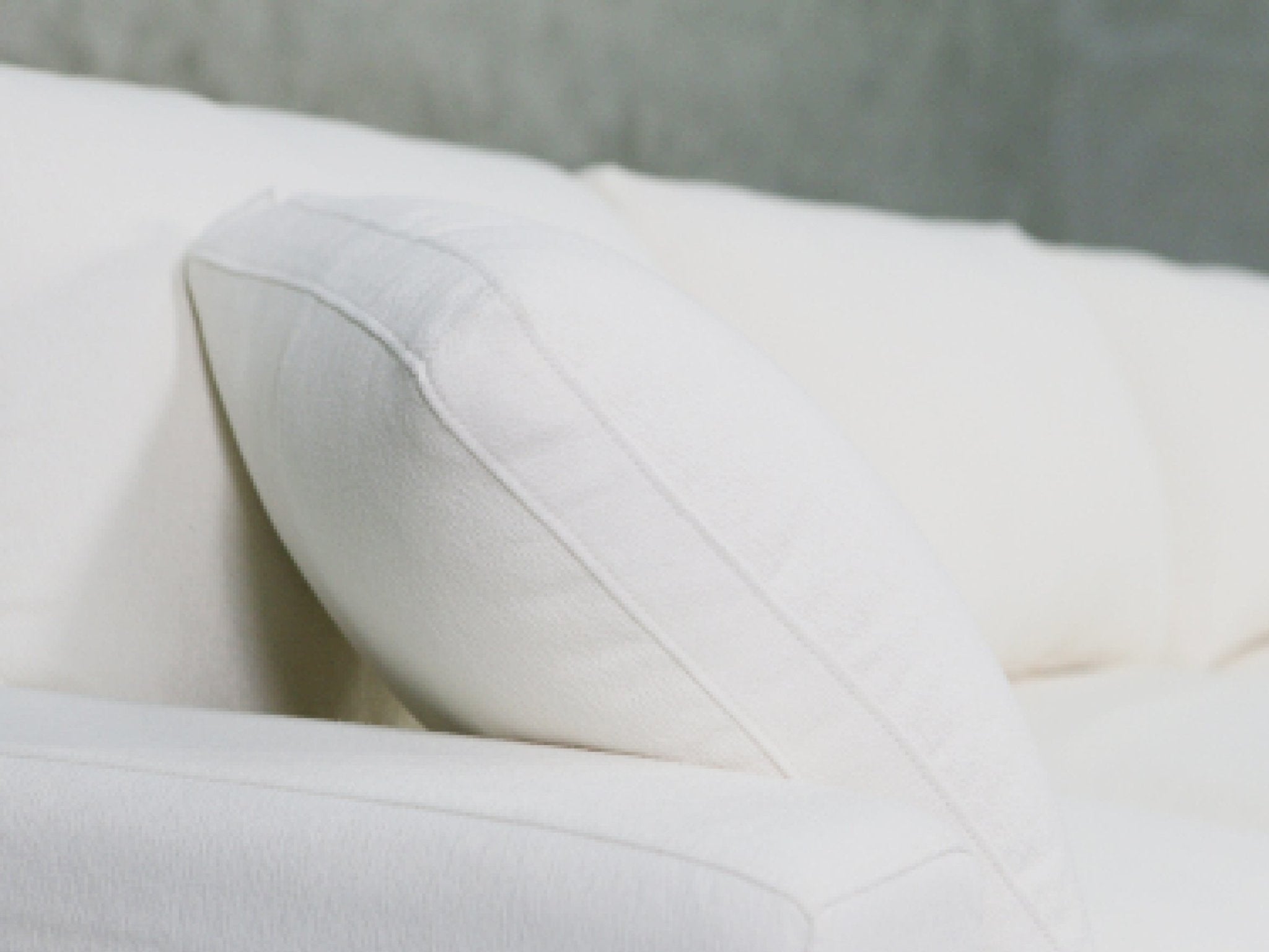 Close-up of pillow stitching on white fabric