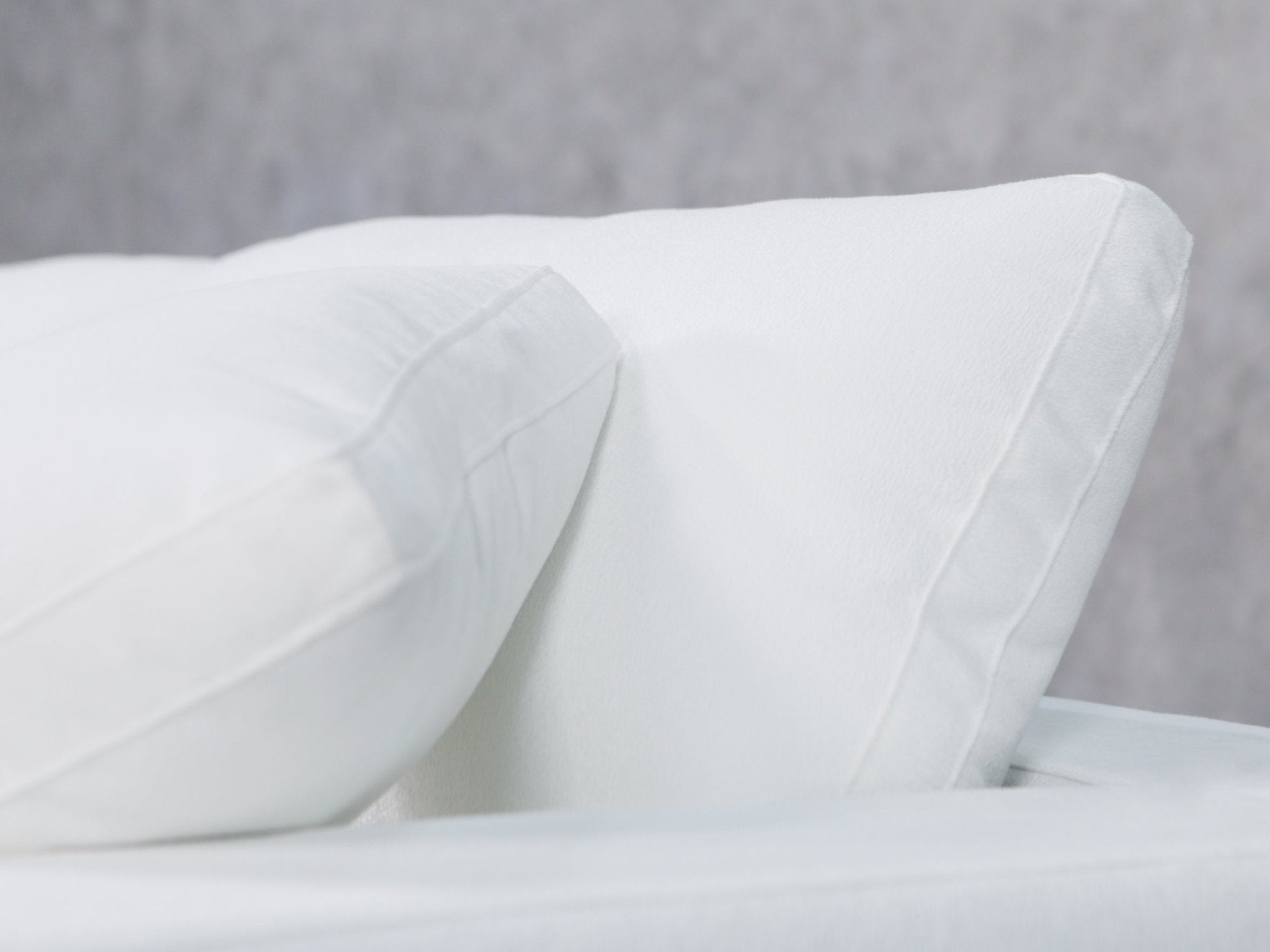 Close-up of a white sofa cushion edge and seam detail
